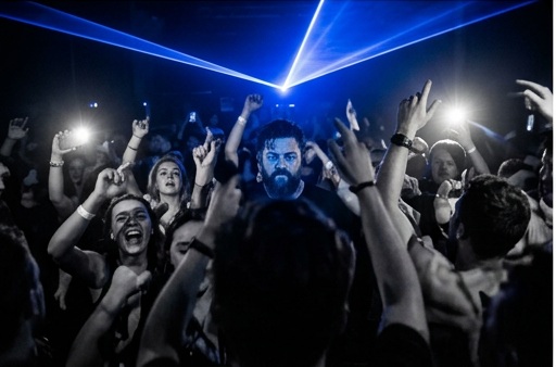Crowd bathed in blue laser light